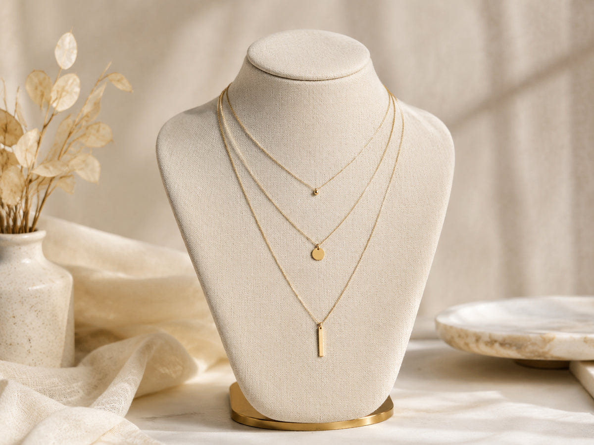 Three necklaces of different lengths arranged on a neutral display