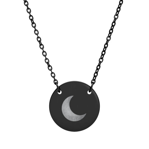 A black disc pendant necklace featuring a brushed silver crescent moon design in the center, suspended from a black link chain against a plain white background.